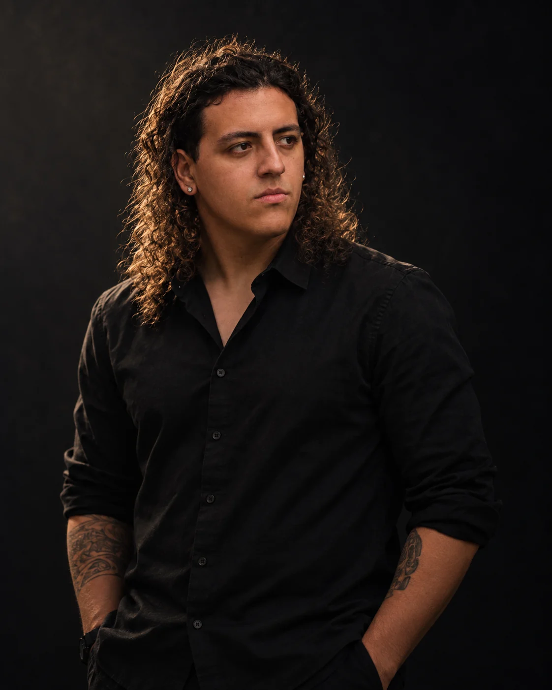 Julian Johnson standing, hands in his pockets, warm light in his hair